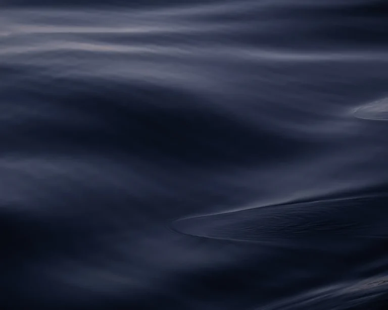Moody view of dark Norwegian sea surface with subtle wave textures and shifting tones