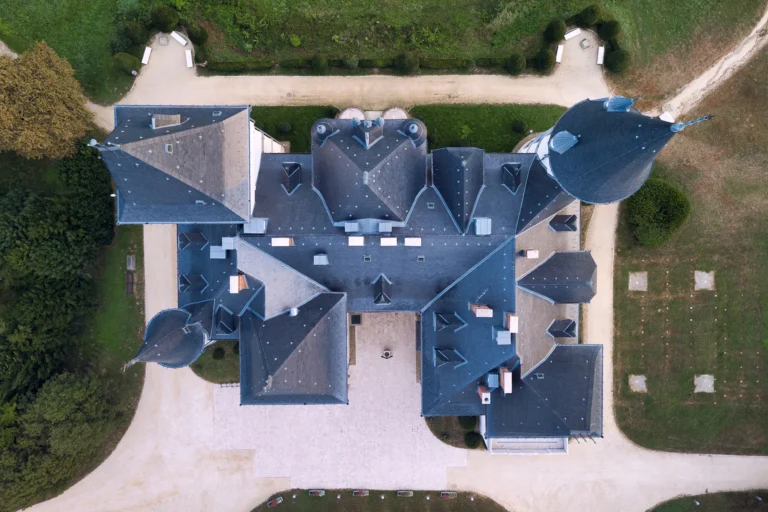 Top-down aerial view of Andrássy Castle in Tiszadob, Hungary with its white turrets and symmetrical roofline